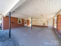 Spacious carport showcasing brick walls and a decorative lattice divider at 2310 Clay St, Kannapolis, NC 28083