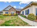 This beautiful home boasts stone accents and vibrant landscaping, creating an inviting curb appeal and charming walkway at 255 Dorothy Dr, China Grove, NC 28023