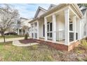 One-story home featuring a charming covered porch with white columns and traditional black railing at 2702 Robyns Glen Dr, Charlotte, NC 28269