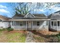 Charming one-story home with covered front porch, white railings, and a welcoming entryway at 314 Flint St, Charlotte, NC 28216
