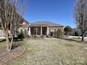Traditional brick home with a well-maintained lawn and mature trees, creating a serene and inviting curb appeal at 315 Drake Park Ave, Fort Mill, SC 29708