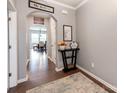 Entryway featuring dark wood floors, gray walls, and arched doorways, creating a warm welcome at 3449 Southern Red Oak Ln, Gastonia, NC 28056