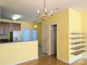 Eat-in kitchen with wood cabinets, white appliances, a tiled floor, and a chandelier at 3812 York Aly, Lake Park, NC 28079
