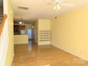 Bright, open living room with hardwood floors, a ceiling fan, and staircase leading to the upper level at 3812 York Aly, Lake Park, NC 28079