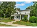 Traditional home with a welcoming front porch and lush landscaping at 401 W Hoke St, Landis, NC 28088