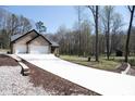 Long driveway leading to a charming brick home featuring an attached two-car garage at 4531 Deer Run None, Rock Hill, SC 29732