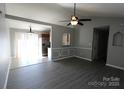 Open-concept living room with luxury vinyl plank flooring and modern ceiling fan at 5809 Carolina Manor Ct, Indian Trail, NC 28079