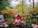 Outdoor seating area with charming table, chair, and a pot of plants with a view of the colorful trees at 5912 Potter S Rd, Waxhaw, NC 28173