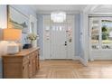 Bright entryway with a crystal chandelier, stylish console table, and beautiful hardwood floors at 846 Wriston Pl, Charlotte, NC 28209