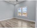 Minimalist bedroom featuring sleek, light floors, neutral walls, and a large window, creating a serene atmosphere at 913 Wilson W Lee Blvd, Statesville, NC 28677