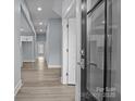 Bright hallway with light wood floors leads to an open-concept space with natural light and fresh paint throughout at 913 Wilson W Lee Blvd, Statesville, NC 28677