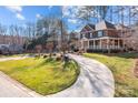 Beautiful brick home with lush landscaping and a winding driveway on a spacious lot surrounded by mature trees at 102 Wyndham Way, Salisbury, NC 28147