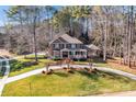 Beautiful brick home with lush landscaping and a winding driveway on a spacious lot surrounded by mature trees at 102 Wyndham Way, Salisbury, NC 28147
