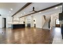 Spacious living room featuring hardwood floors, exposed beams, and lots of natural light at 106 Pecan Cove Ln, Weddington, NC 28104