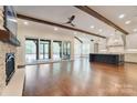 Open-concept living space featuring a fireplace, hardwood floors, and a view of the backyard at 106 Pecan Cove Ln, Weddington, NC 28104
