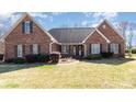 Charming brick home featuring a well-manicured lawn and classic design elements at 1114 Setter Ln, Concord, NC 28025