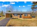Charming single-story brick home with a covered carport and manicured landscaping in a well-lit setting at 114 Downing St, Troutman, NC 28166
