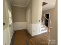Welcoming entryway with wainscoting, stairs, and stylish details throughout at 11533 Valley Oaks Ln, Stanfield, NC 28163