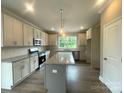 Spacious kitchen with granite countertops, an island, stainless steel appliances, and ample cabinet space at 11533 Valley Oaks Ln, Stanfield, NC 28163