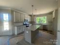 Bright kitchen features white cabinets, granite countertops, and stainless steel appliances at 11533 Valley Oaks Ln, Stanfield, NC 28163