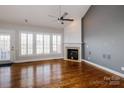 Bright living room with hardwood floors, fireplace, and doors to the outside at 11609 Mersington Ln, Charlotte, NC 28277