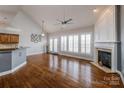 Spacious living room with hardwood floors, fireplace, and large windows with plantation shutters at 11609 Mersington Ln, Charlotte, NC 28277