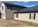 Exterior view of a home with horizontal siding, a dark metal roof, and black window shutters at 1174 Trexler Rd, Salisbury, NC 28146