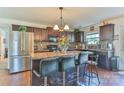 Kitchen featuring an island, stainless steel refrigerator, and dark wood cabinets at 137 Mossy Pond Rd, Statesville, NC 28677