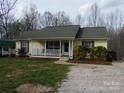 Charming home with a cozy front porch and mature landscaping creating curb appeal at 14440 W Highway 55 Hwy, Blacksburg, SC 29702
