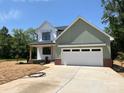 Charming two-story home with white and green siding, a two-car garage, and a well-manicured front yard at 1906 Maius Dr, Conover, NC 28613