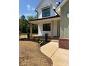 A charming home featuring a welcoming front porch with stylish wooden pillars and manicured garden beds at 1906 Maius Dr, Conover, NC 28613