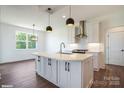 Modern kitchen boasts a large center island with white countertops and contemporary pendant lighting fixtures at 1906 Maius Dr, Conover, NC 28613