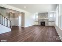 Bright living room features a stone fireplace, wood floors, and large windows offering plenty of natural light at 1906 Maius Dr, Conover, NC 28613