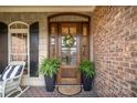 Close-up of a charming front door with a floral wreath and inviting curb appeal at 2028 Fitzhugh Ln, Weddington, NC 28104