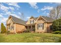 Elegant home showcasing a beautifully landscaped front yard and classic architectural details at 2028 Fitzhugh Ln, Weddington, NC 28104