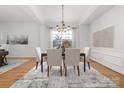 Formal dining room with large windows, chandelier, and neutral decor, adjacent to the living room at 226 Fairview Ln, Davidson, NC 28036