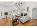 Spacious living room with vaulted ceiling, large windows, fireplace, and hardwood floors at 226 Fairview Ln, Davidson, NC 28036