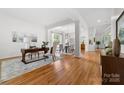 Bright living area featuring hardwood floors, decorative columns, and an adjacent dining area at 226 Fairview Ln, Davidson, NC 28036