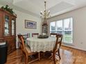 Cozy dining room featuring hardwood floors, chandelier, and natural light at 2339 Perry Rd, Denver, NC 28037