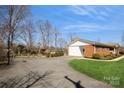 Long driveway leading to a spacious garage and a well-kept backyard at 2417 Fowler Secrest Rd, Monroe, NC 28110