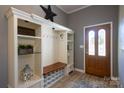 Functional entryway with custom built-ins, a bench, and storage for shoes and coats at 2417 Fowler Secrest Rd, Monroe, NC 28110