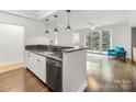 Kitchen with stainless steel appliances, a granite countertop, a breakfast bar and view to the bright living room at 300 W 5Th W St # 407, Charlotte, NC 28202