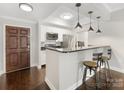 Stylish kitchen features stainless steel appliances, granite countertops, breakfast bar and hardwood floors at 300 W 5Th W St # 407, Charlotte, NC 28202