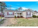 Lovely single-story house featuring red shutters and a neat front yard with a convenient carport on the side at 340 Vernon Ln, Statesville, NC 28677