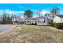 Charming single-story home featuring a carport and a well-maintained front yard with budding plants at 340 Vernon Ln, Statesville, NC 28677