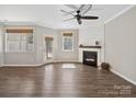 Bright living room with a shiplap fireplace, a ceiling fan, and hardwood floors at 3441 Scottish Fern Ln, Indian Land, SC 29707