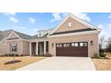 Beautiful brick home boasting a spacious driveway and a meticulously maintained lawn at 4034 Sagemont Nw Dr, Concord, NC 28027