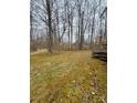 The large backyard is surrounded by woods and has a small wood deck at the side entrance at 410 Johnstone Rd, Cleveland, NC 27013