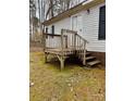 The side entrance features a wood deck and steps, providing access to the home at 410 Johnstone Rd, Cleveland, NC 27013