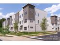 Modern townhouse exterior showcasing a combination of brick and siding, complemented by neat landscaping and curb appeal at 5007 Nimes Rd # 28, Charlotte, NC 28208